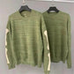 Pull vert avec motif de squelette