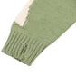 Pull vert avec motif de squelette