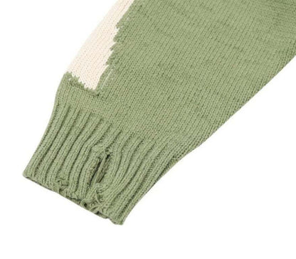 Pull vert avec motif de squelette