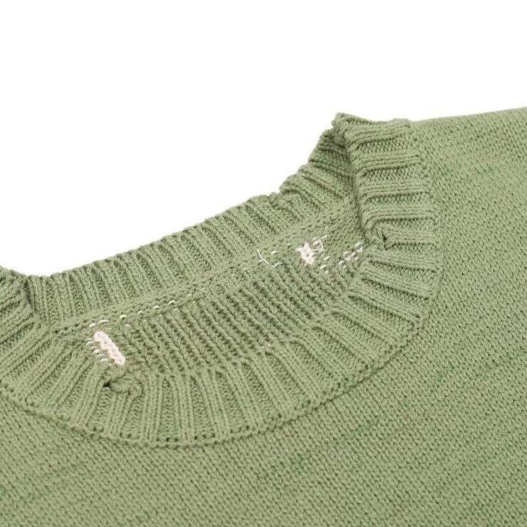 Pull vert avec motif de squelette